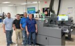 Slate Group team in front of Duplo DDC-810